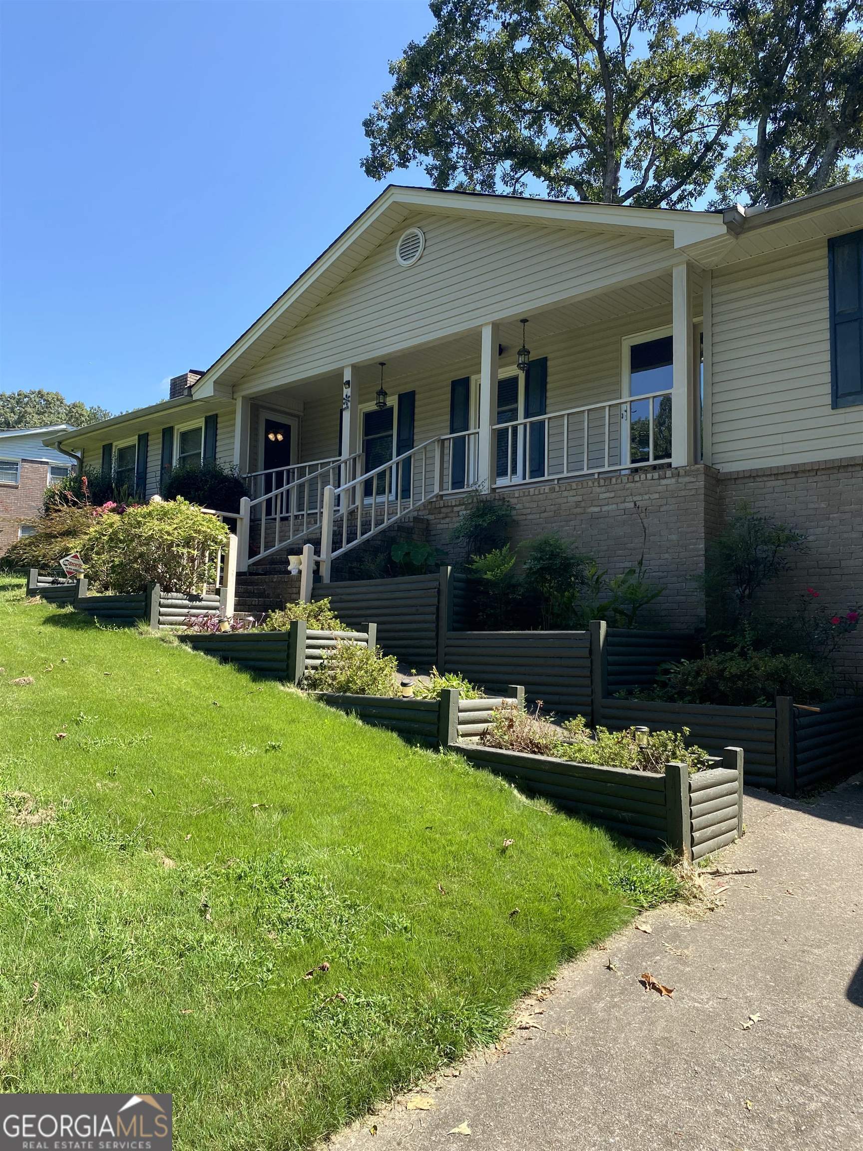 a front view of house with yard and outdoor seating