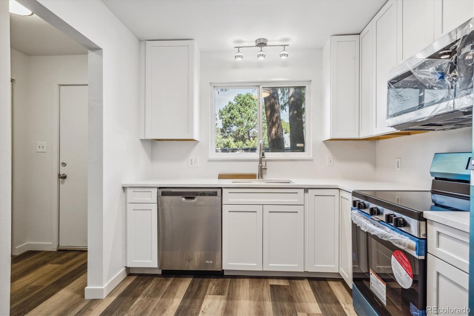 a kitchen with cabinets appliances and a window