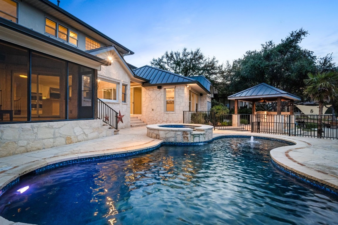 a view of a house with swimming pool and sitting area