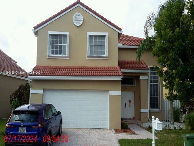 a front view of a house with parking space