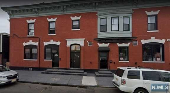 a front view of a house with parking space