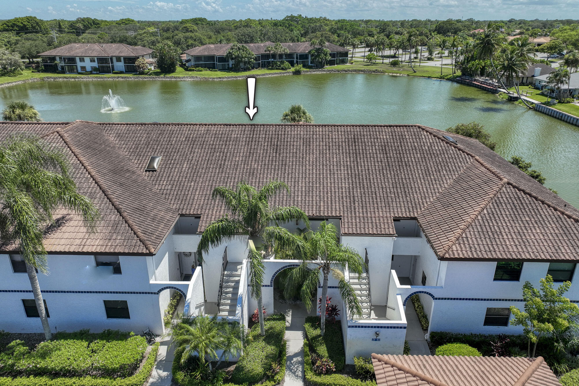 an aerial view of house with outdoor space and lake view