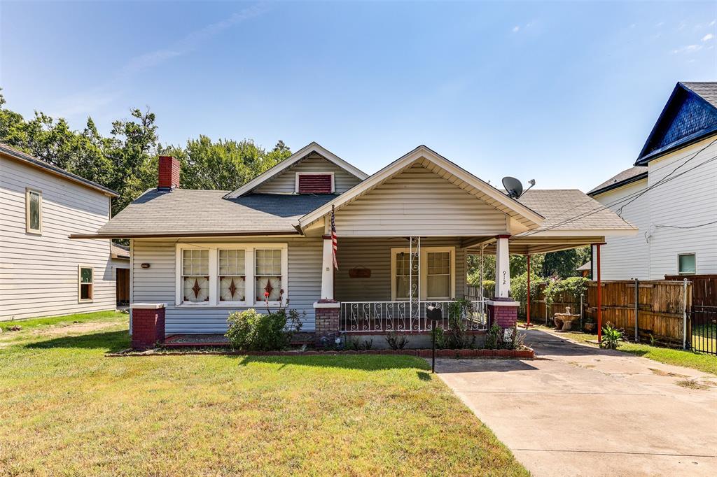 a front view of a house with a porch and a yard