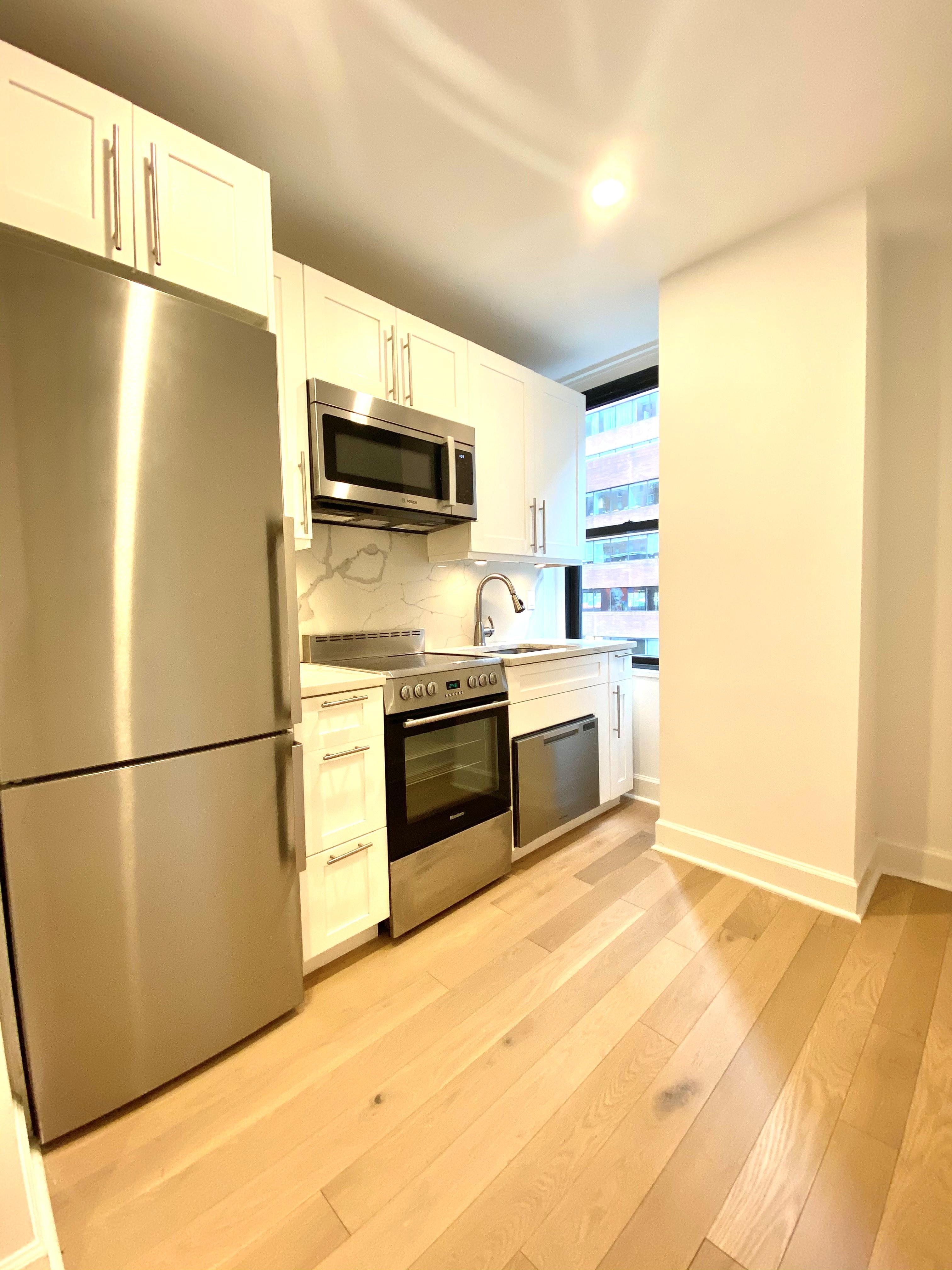 a kitchen with stainless steel appliances a refrigerator and a stove top oven