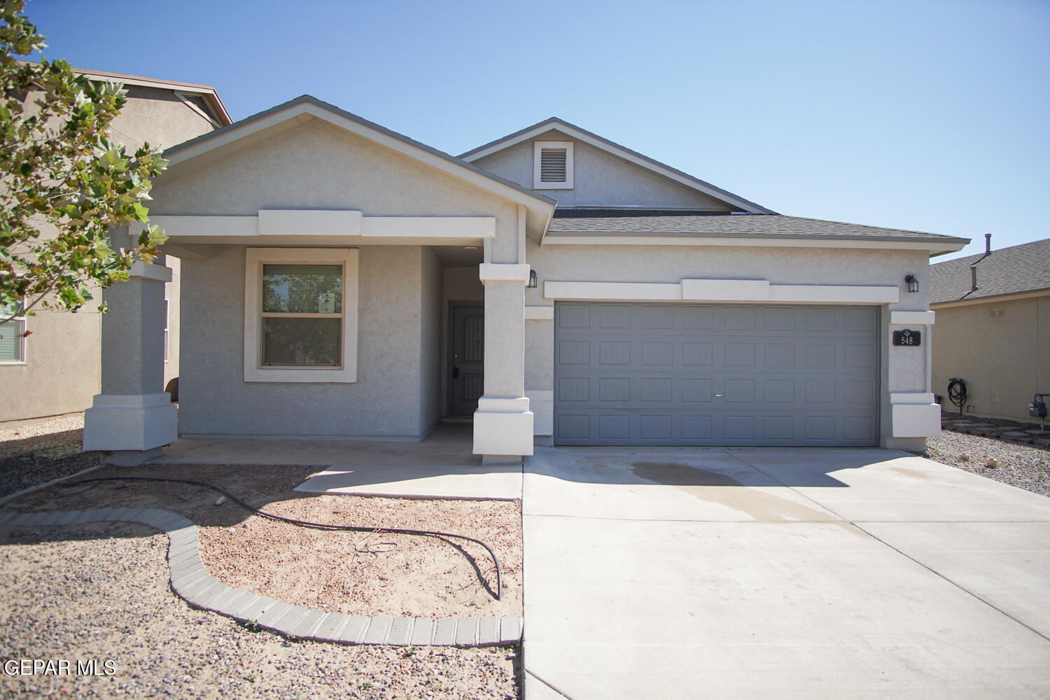 a front view of a house with a garage