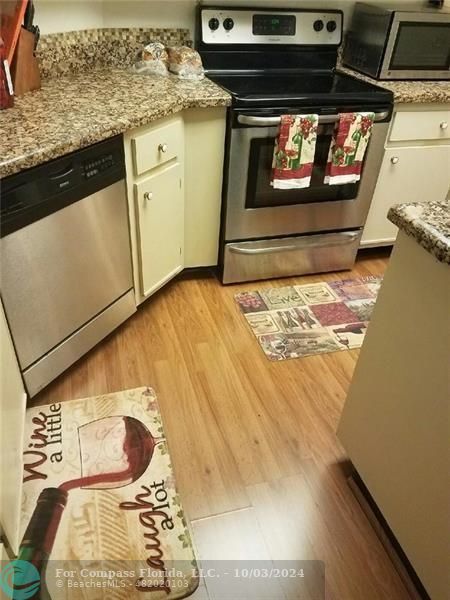 a kitchen with a stove and a microwave