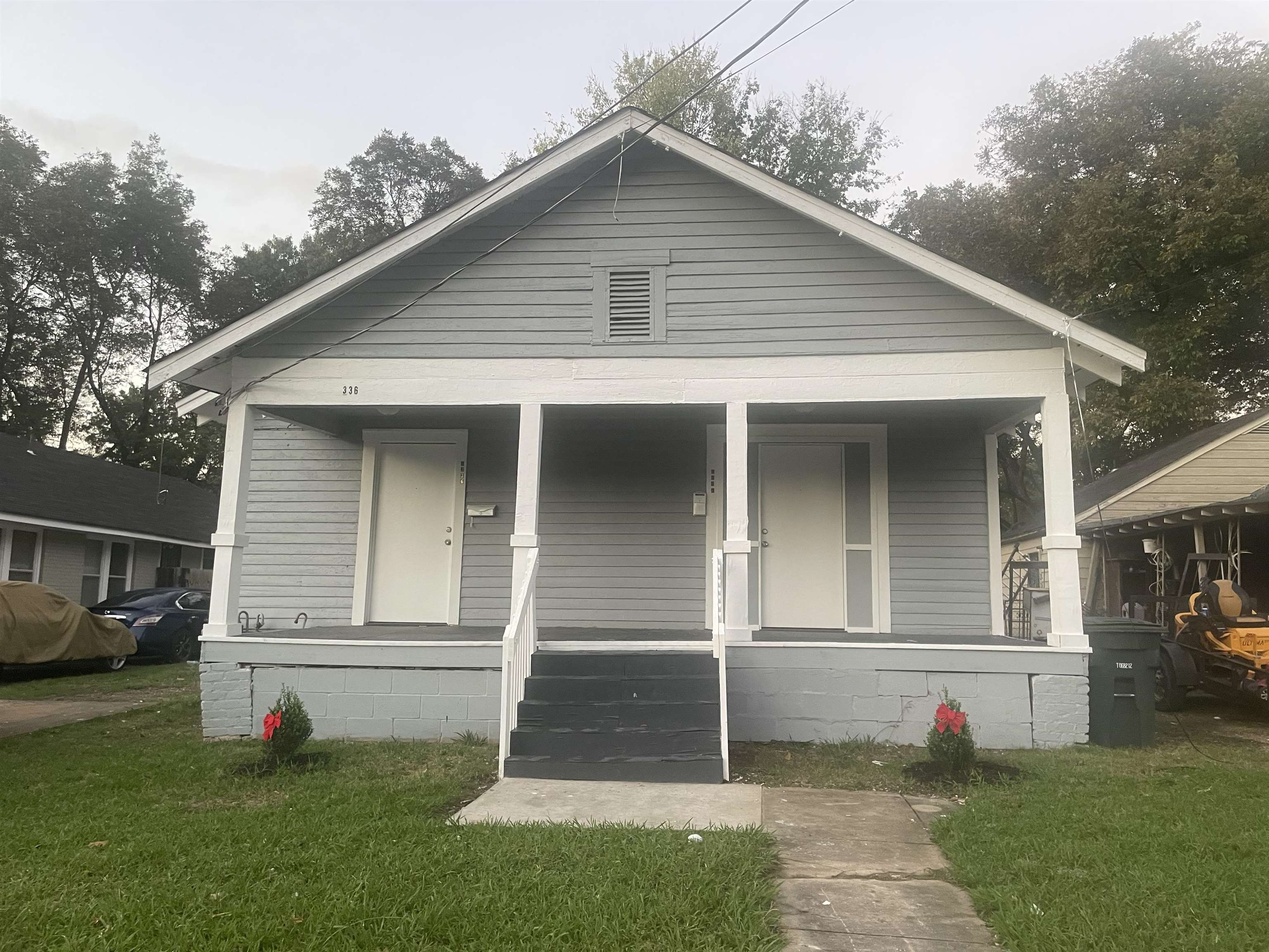 Bungalow-style house featuring a front yard and covered porch