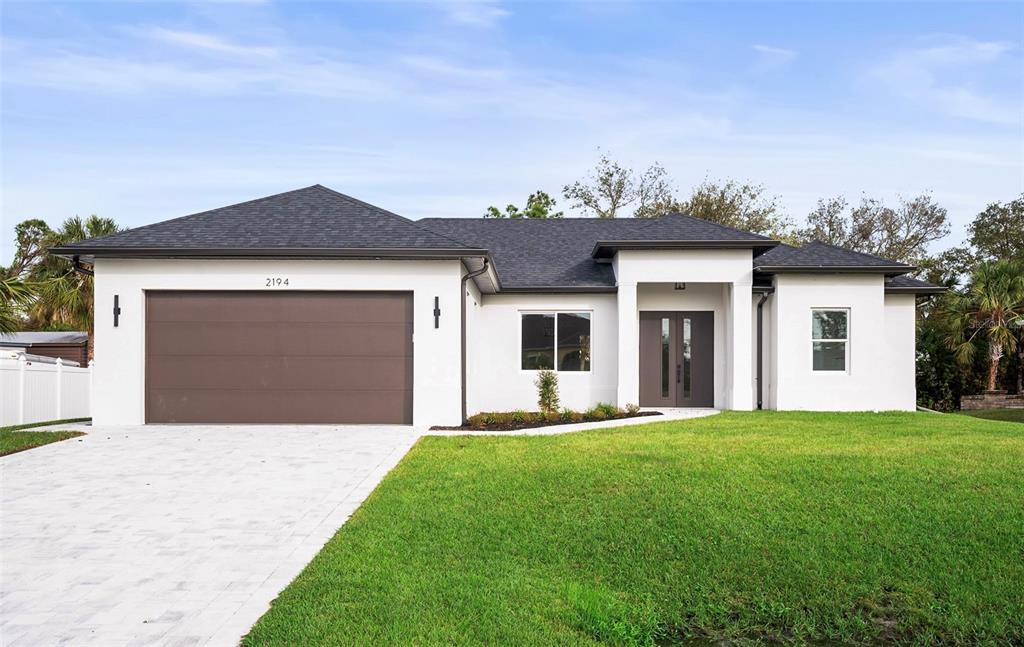 a front view of a house with a yard and garage