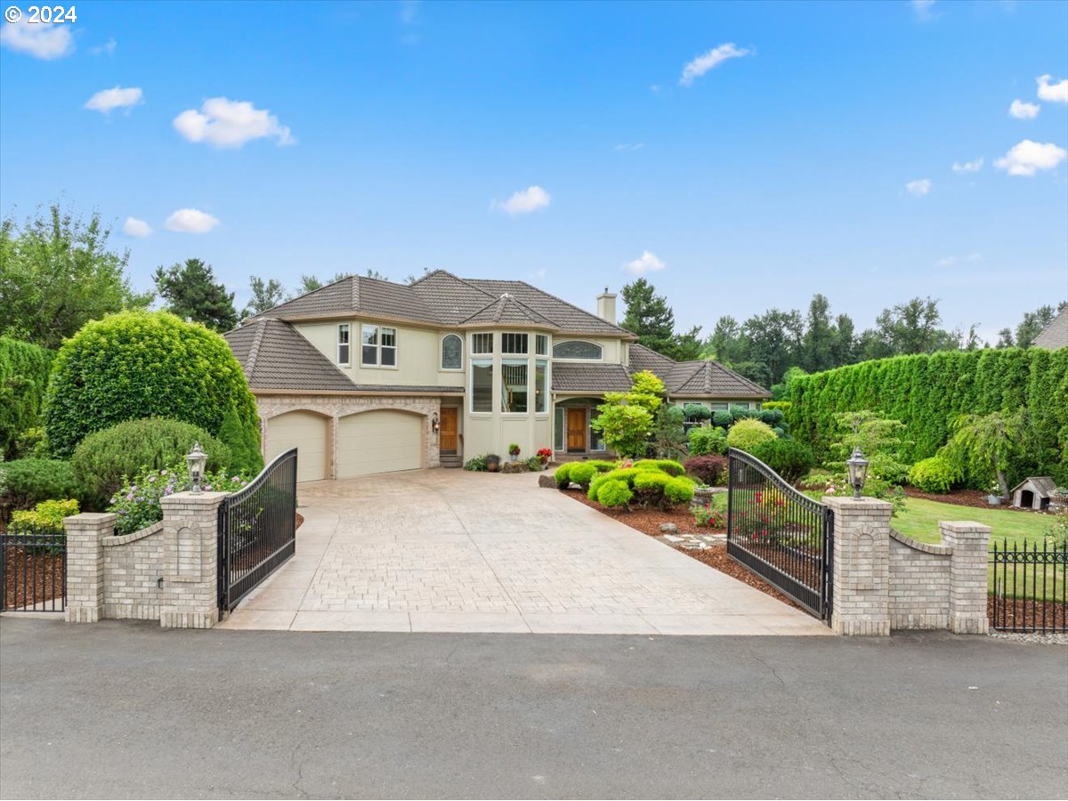 a front view of a house with a yard and garage