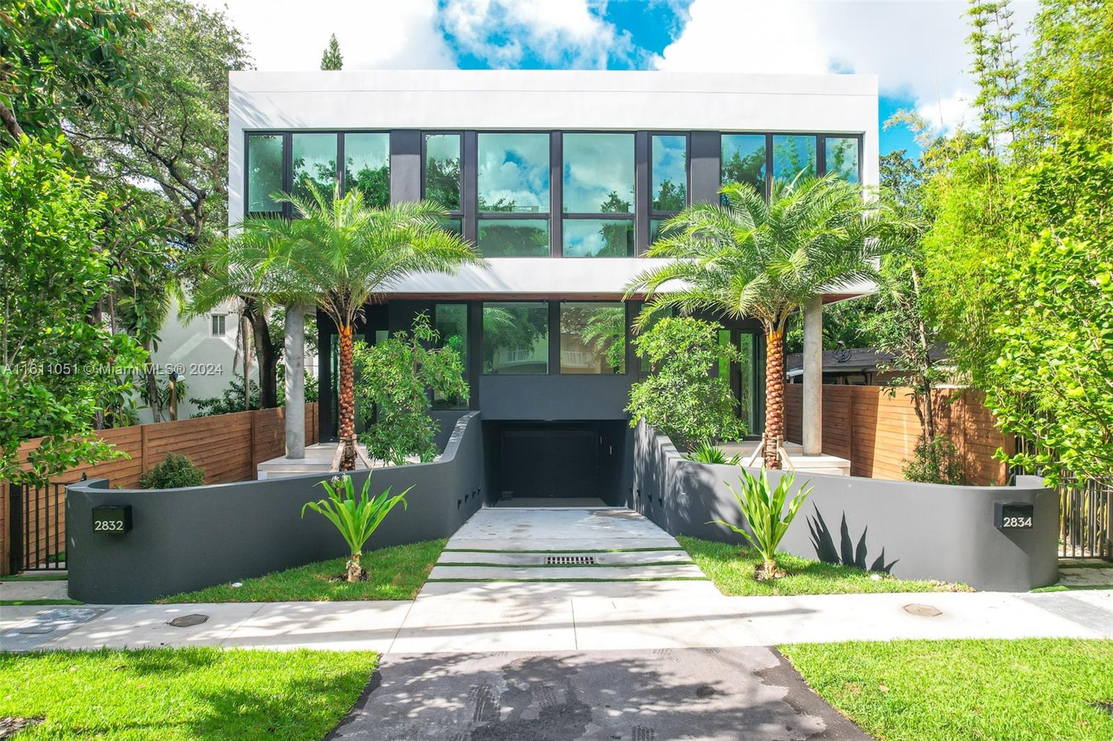 a view of a house with a yard and plants