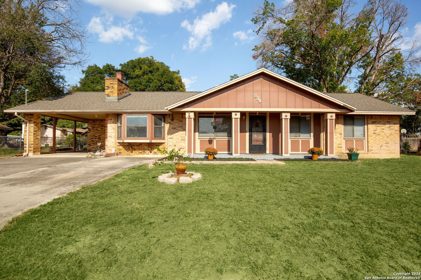 a view of a house with a yard patio and a garden