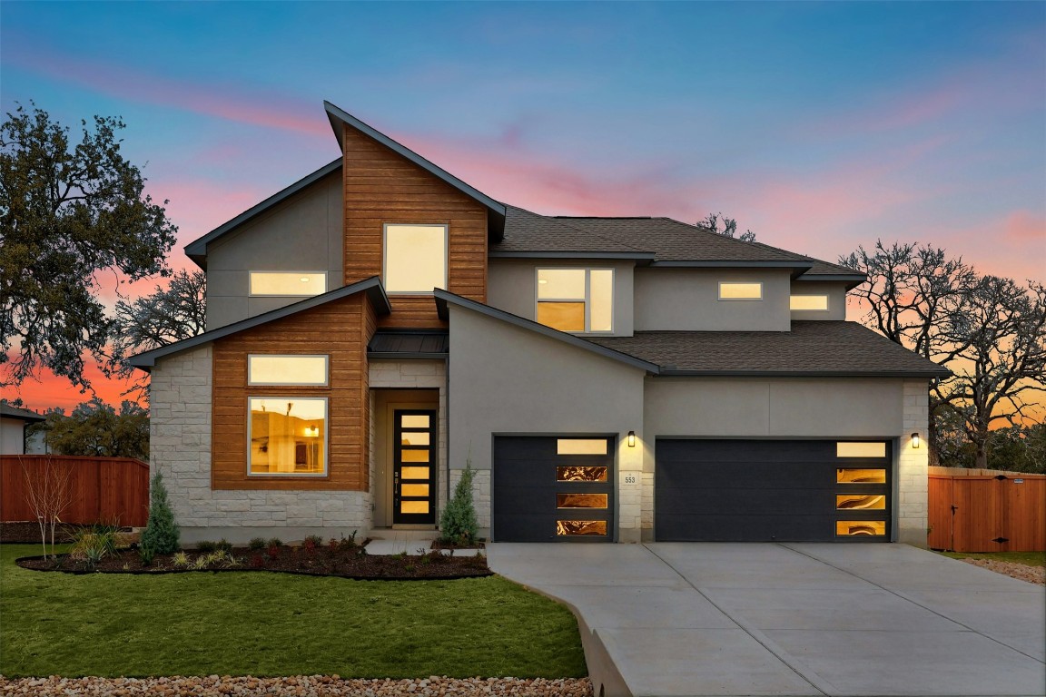 a front view of a house with a yard and garage