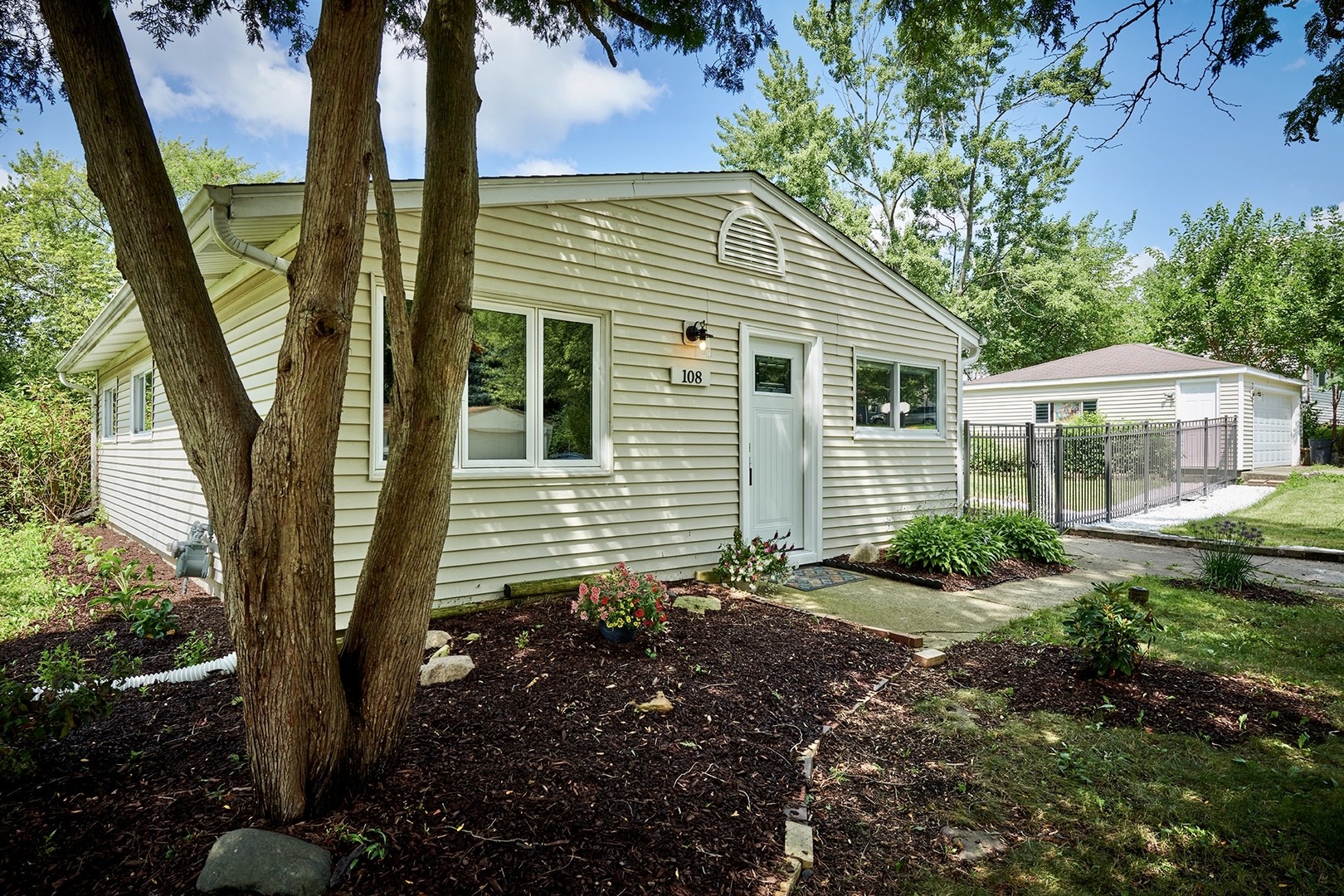 a front view of a house with garden