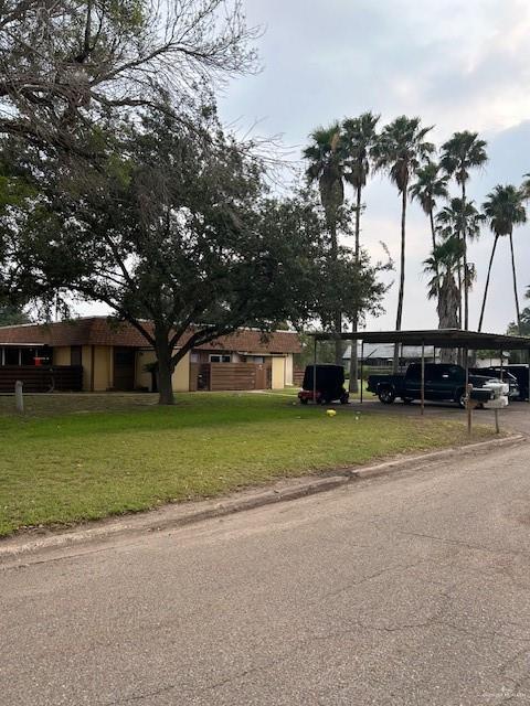 a front view of a house with a garden and trees