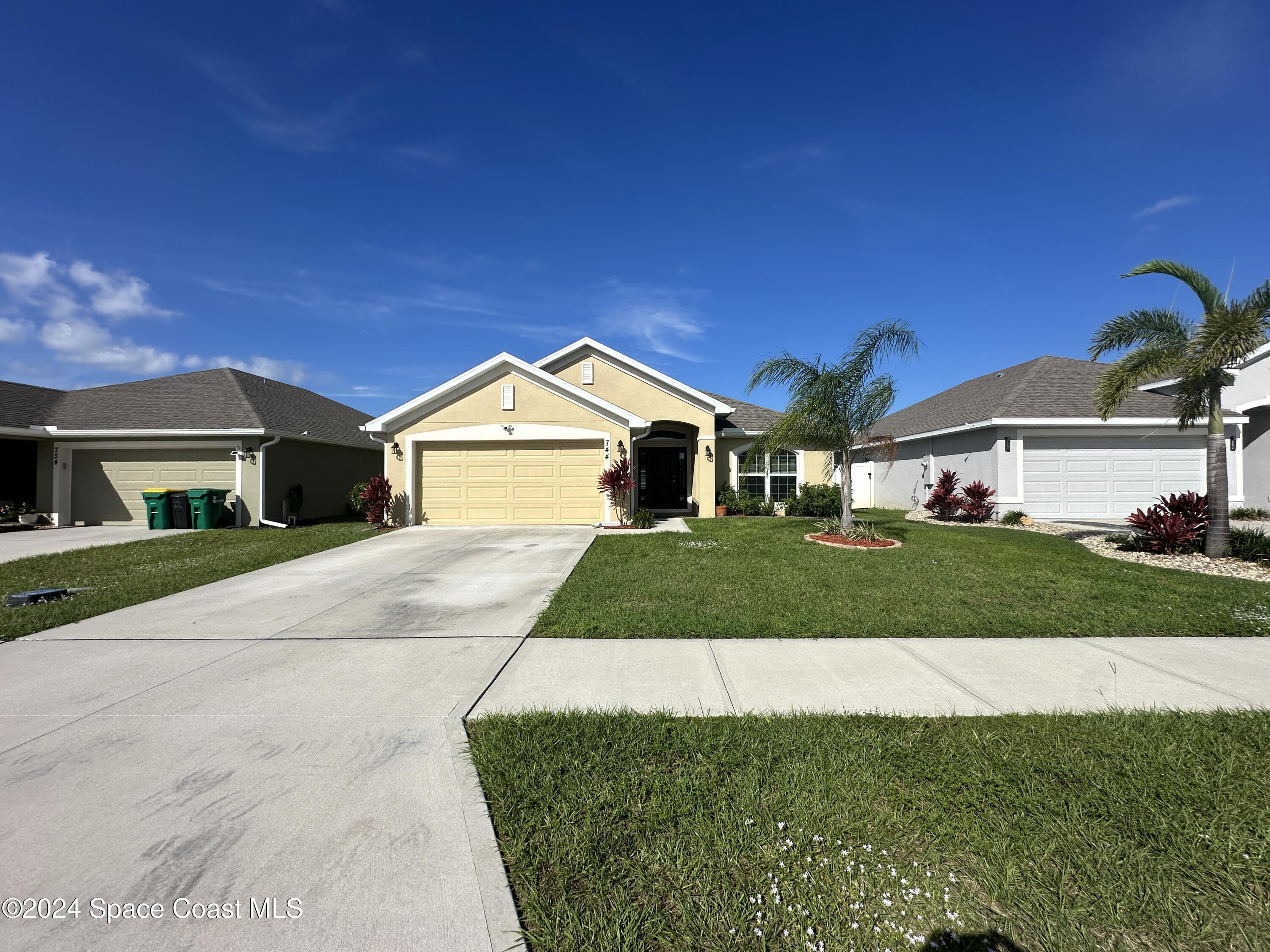 a front view of a house with a yard