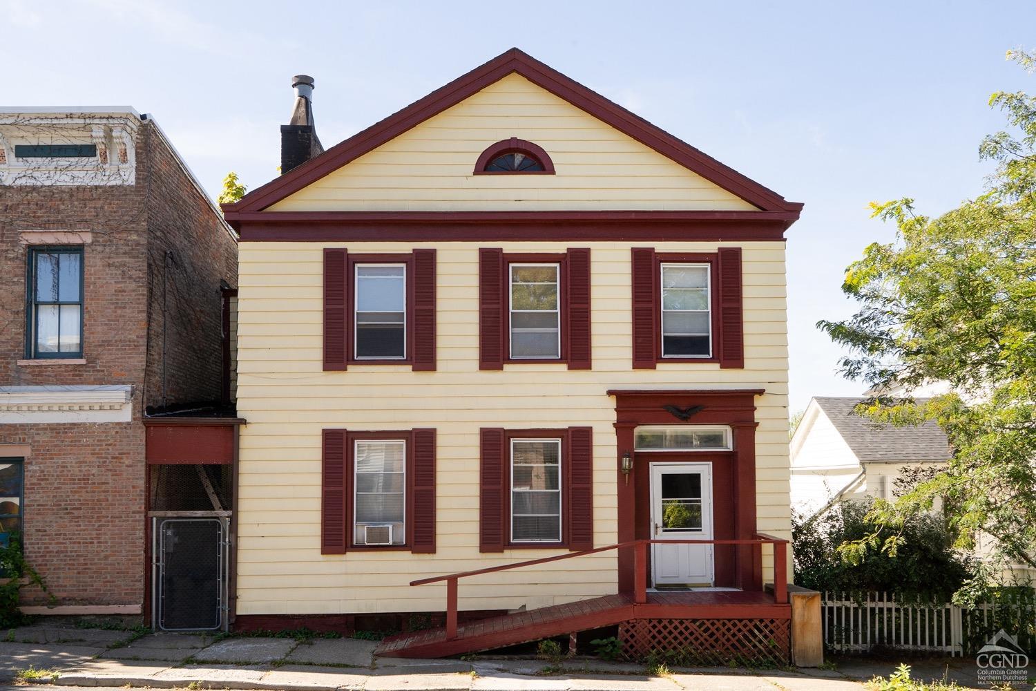 a front view of a house with a yard