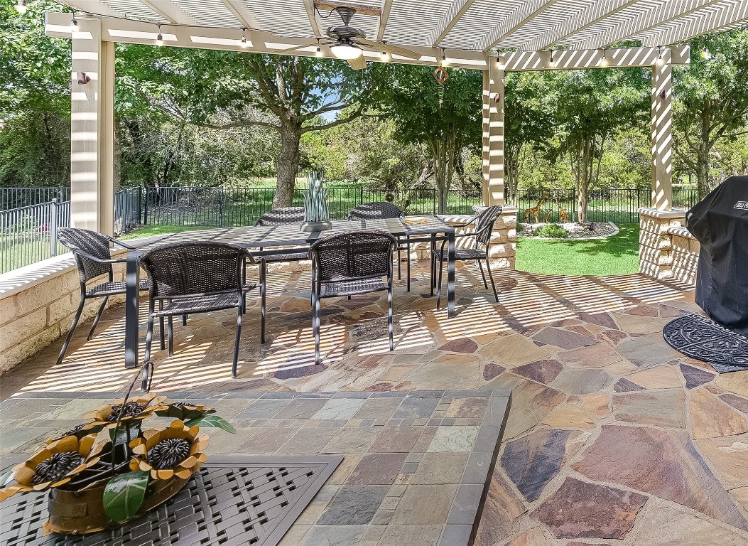 a view of a patio with table and chairs and potted plants