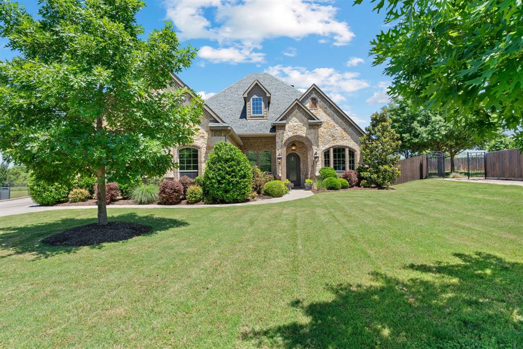 a front view of house with yard and green space