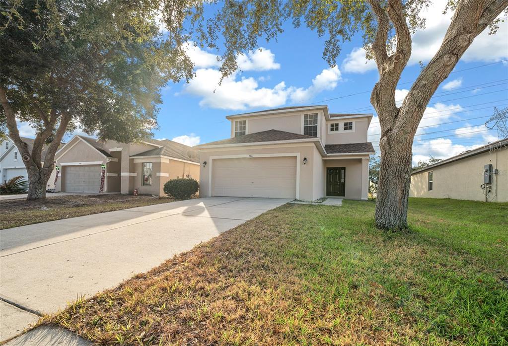 a front view of a house with a yard and garage