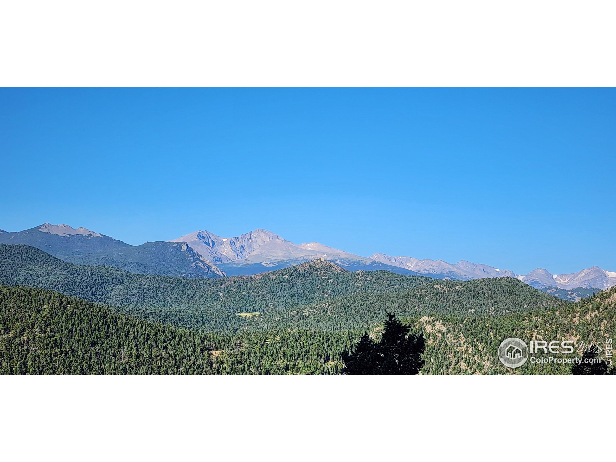 a view of mountain with sunset in background