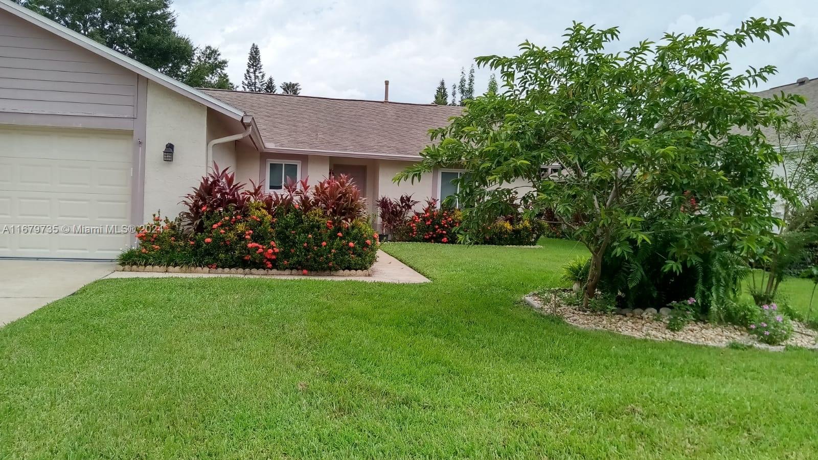 a view of a house with garden and plants