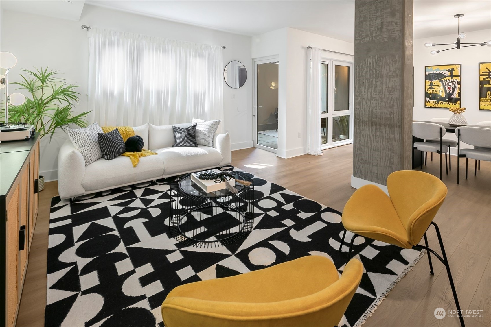 a living room with furniture and a potted plant