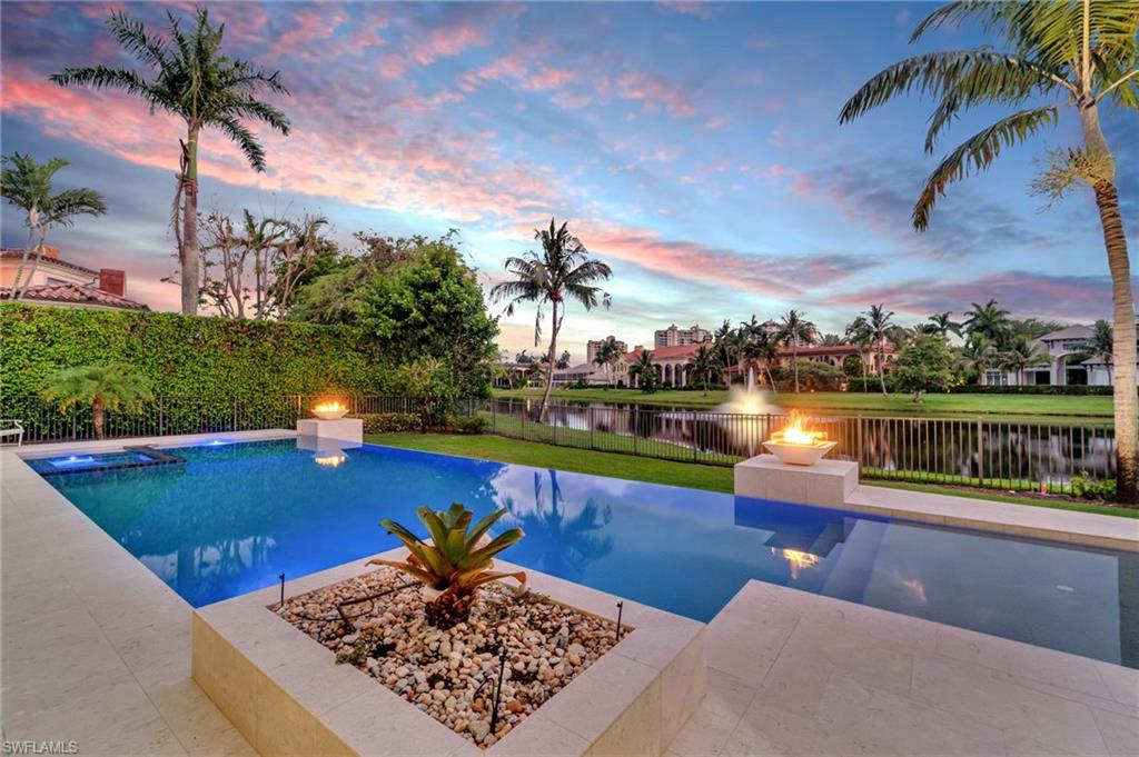 a view of a swimming pool with a patio and a garden