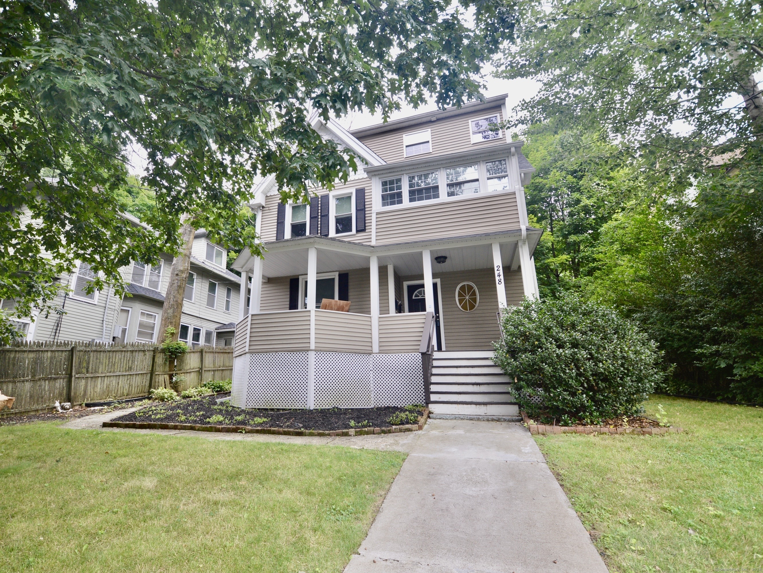 a front view of house with yard and green space