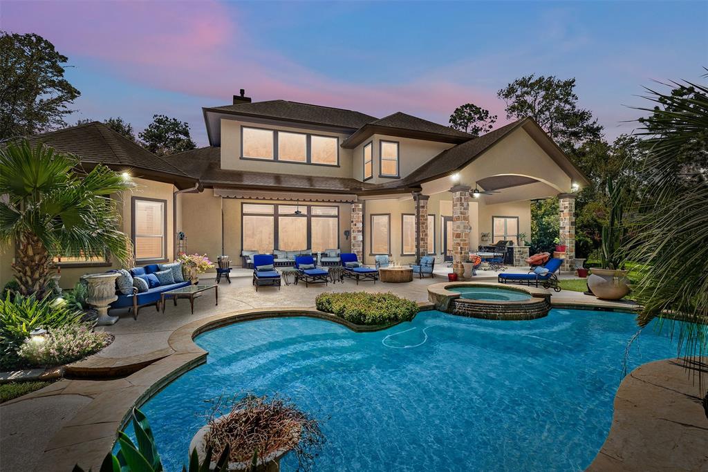 a view of a house with swimming pool and sitting area