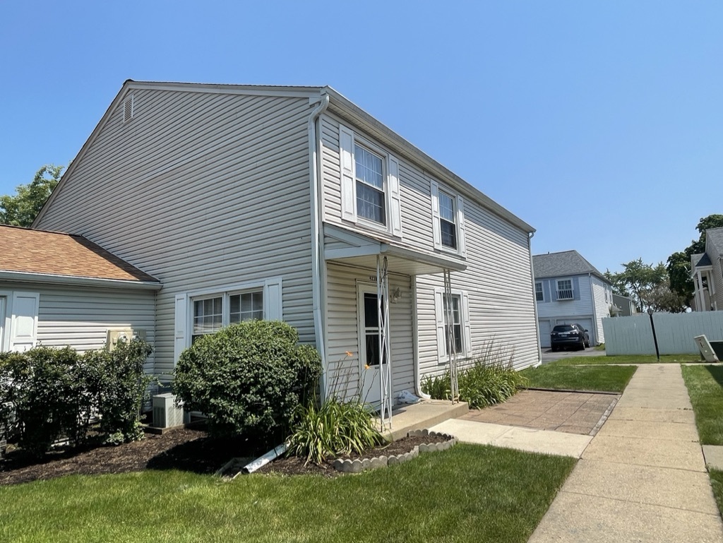 a front view of house with yard and green space