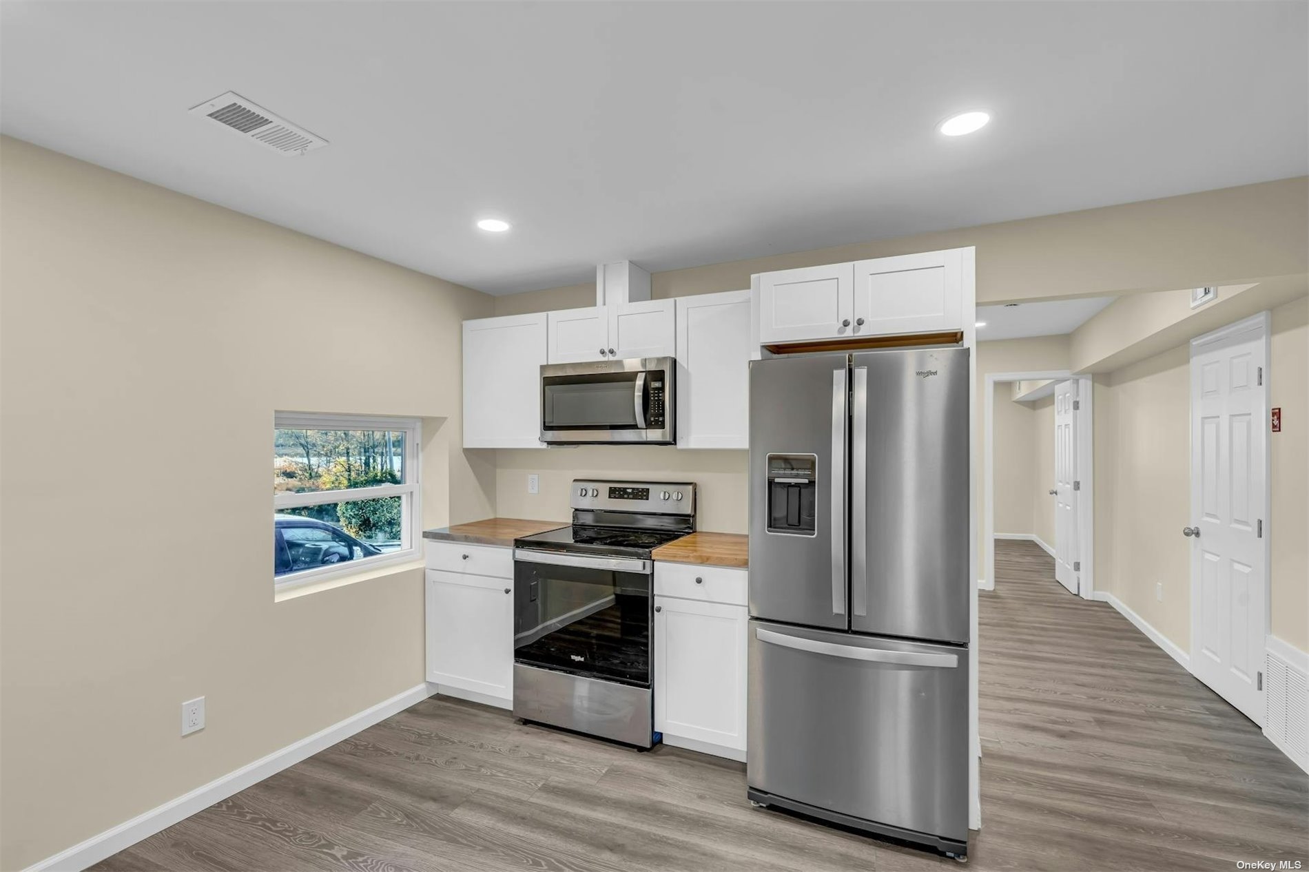 a kitchen with stainless steel appliances a refrigerator sink and microwave