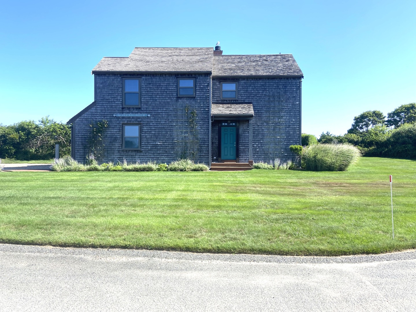 a view of a brick house with a yard