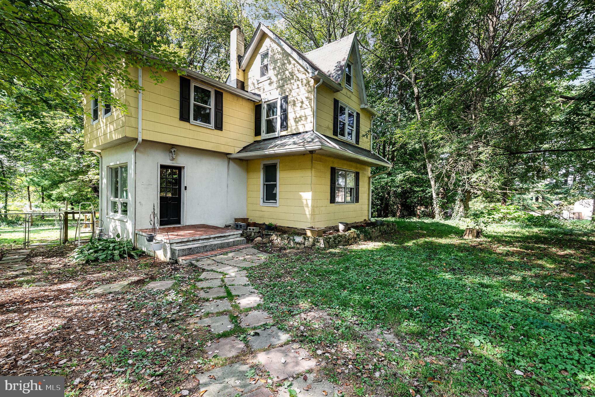 a front view of house with yard and trees