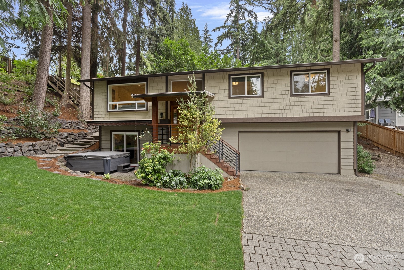 a front view of a house with a garden and plants