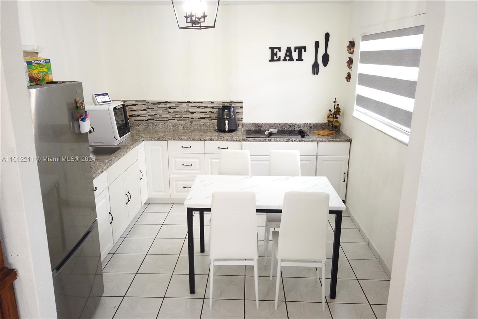 a white kitchen with a stove top oven