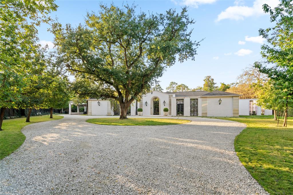 a front view of a house with a yard and trees