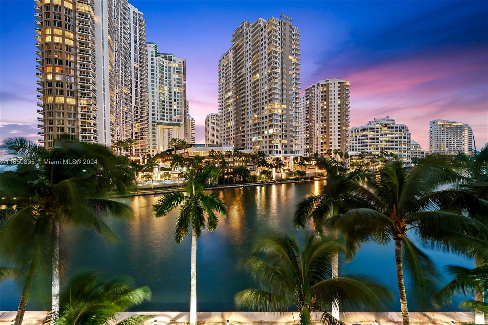 a view of lake and city with tall buildings