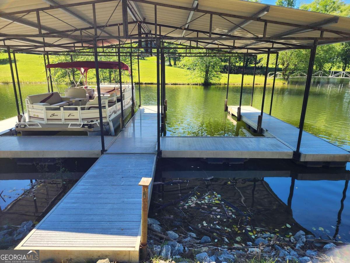 a view of a swimming pool with a patio and lake view