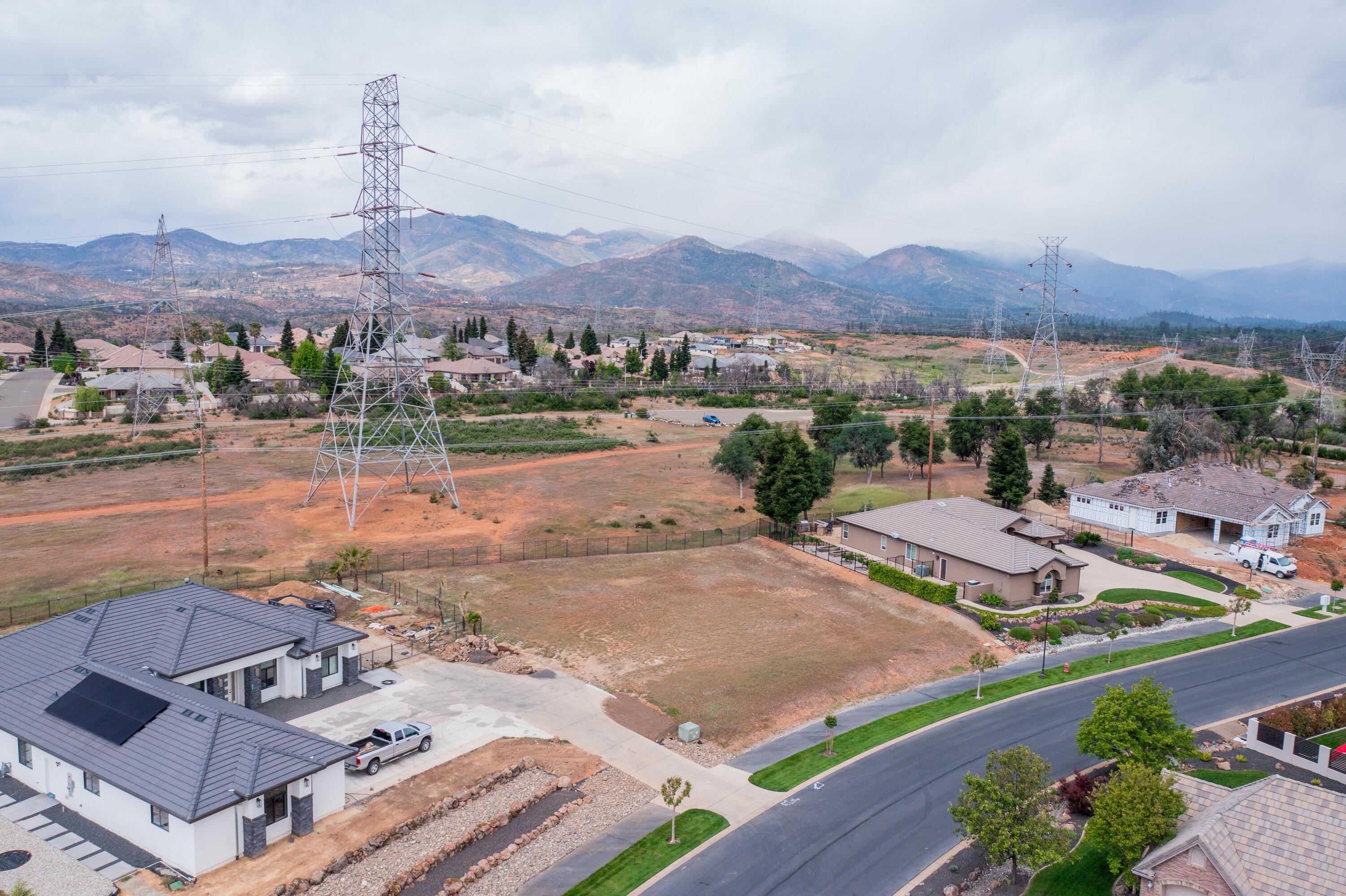 an aerial view of a house with yard and mountain view