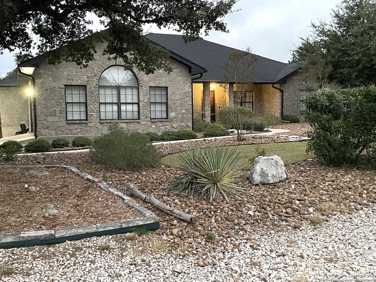 a front view of a house with garden