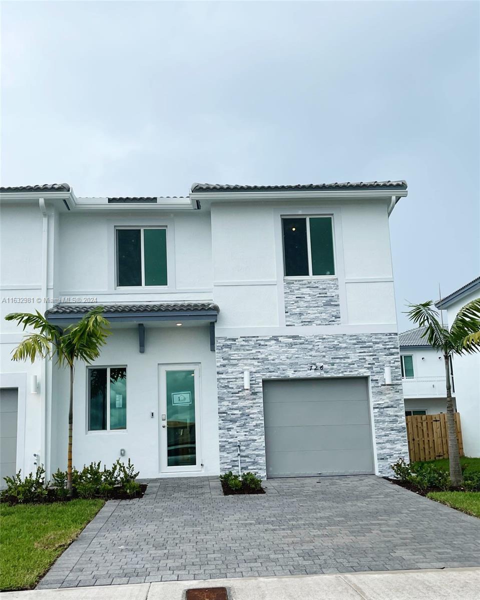 a front view of a house with garage