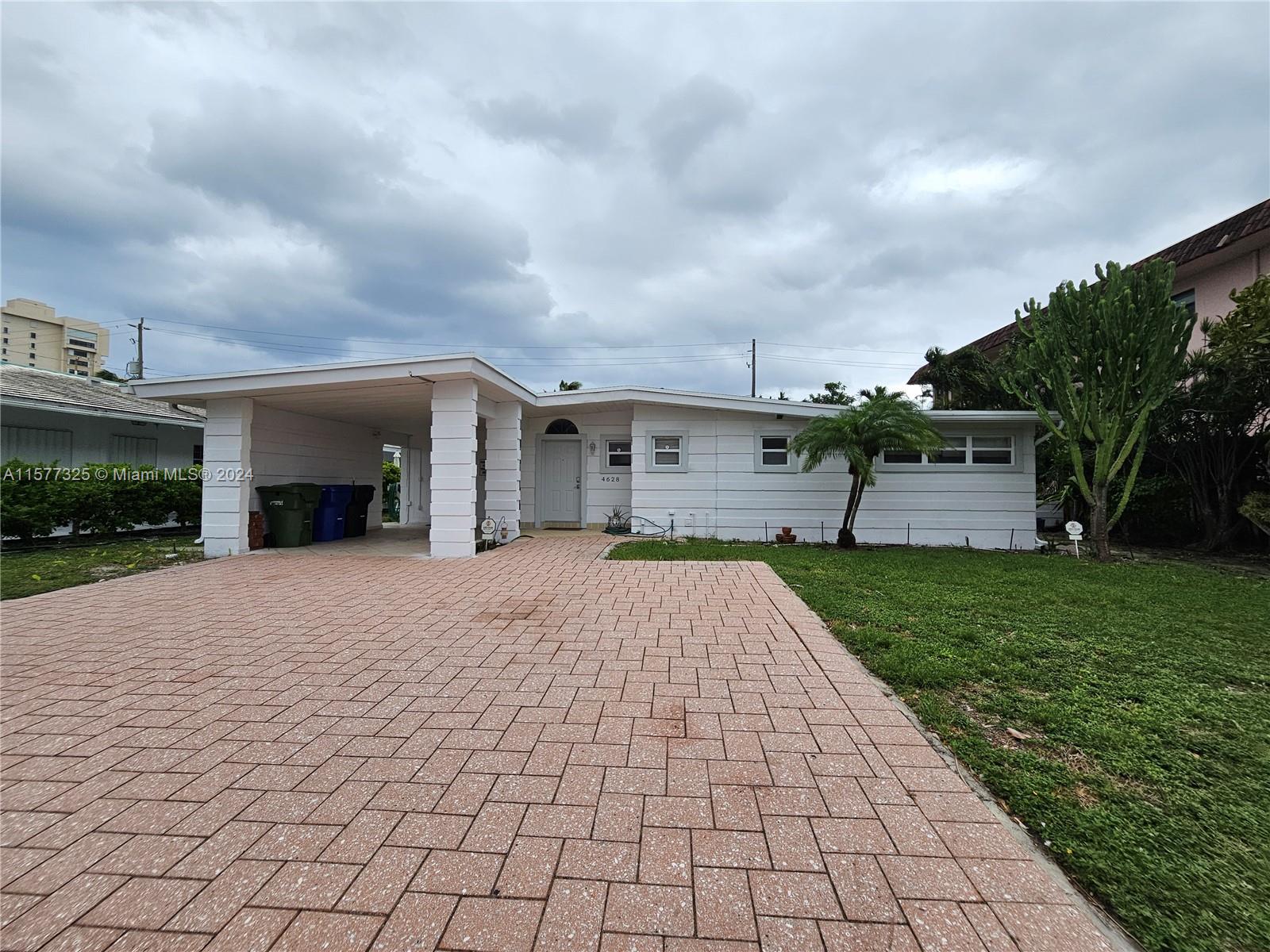 a front view of a house with a yard and a garage