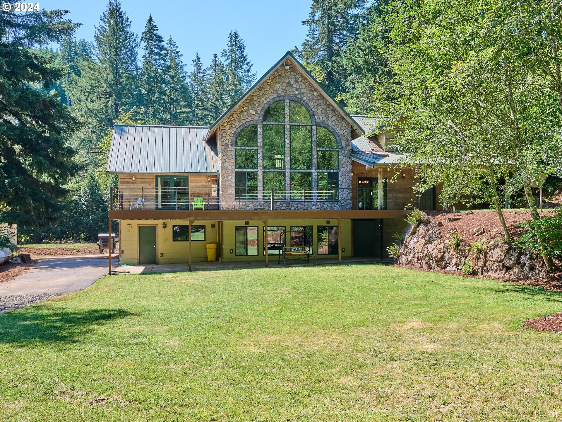 a view of a house with a yard and sitting area