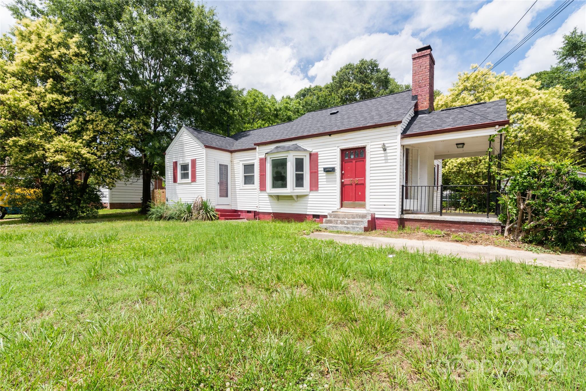 a front view of house with yard and green space