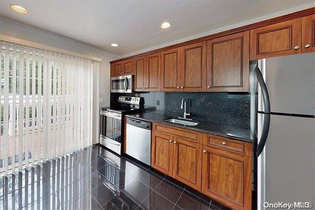 a kitchen with stainless steel appliances granite countertop a refrigerator sink and cabinets