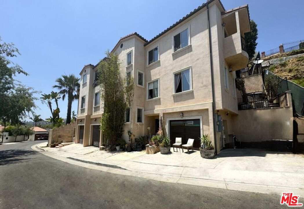 a view of a house with a yard in front of it