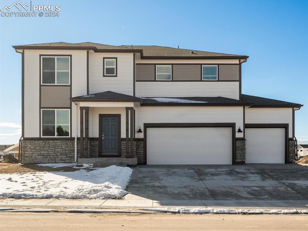 View of front of home featuring a garage