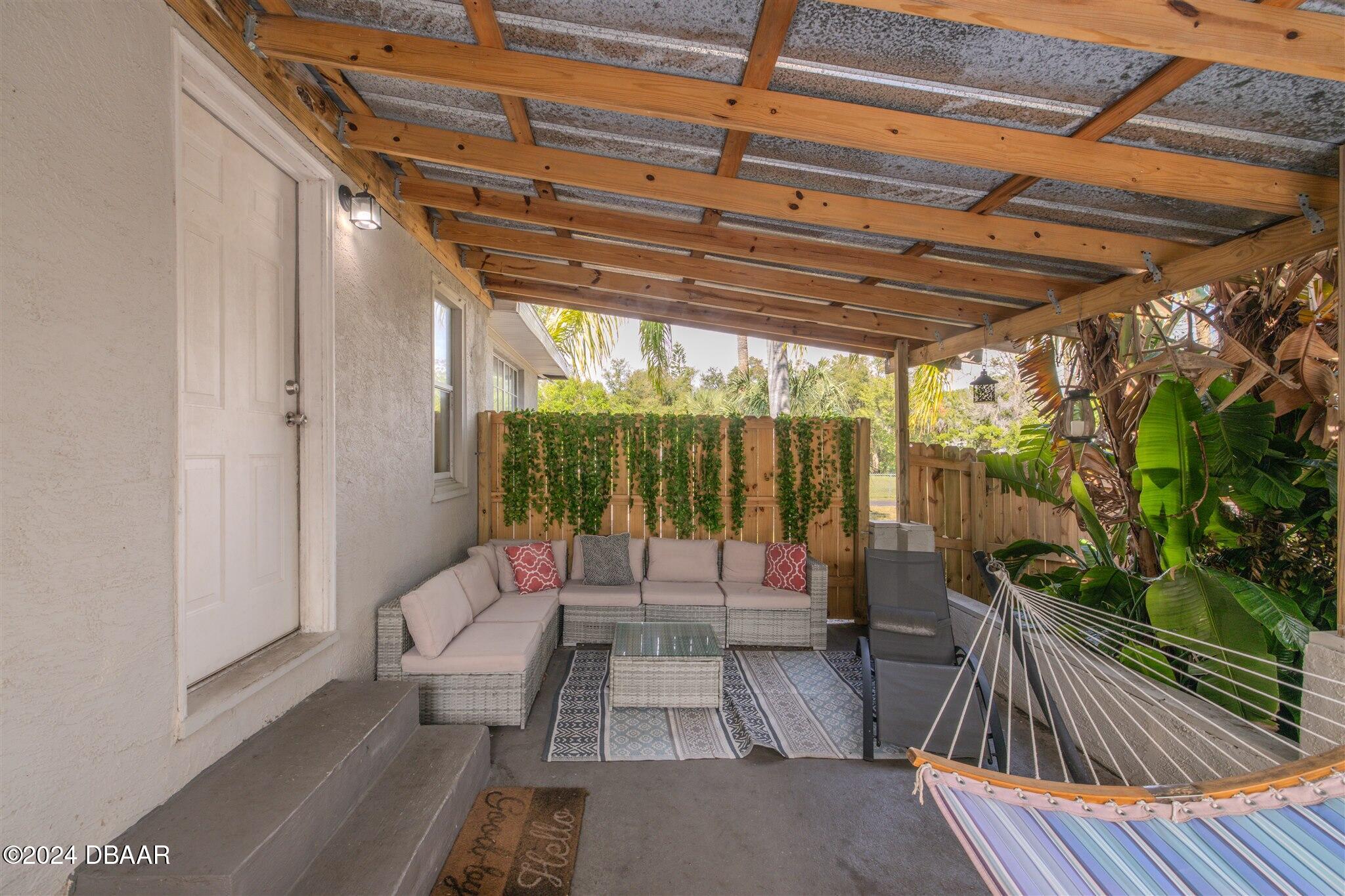 a building outdoor space with patio furniture and potted plants