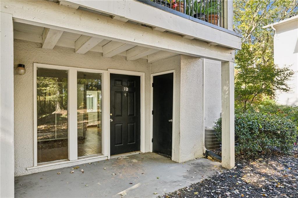 a view of a porch with a door and a chair