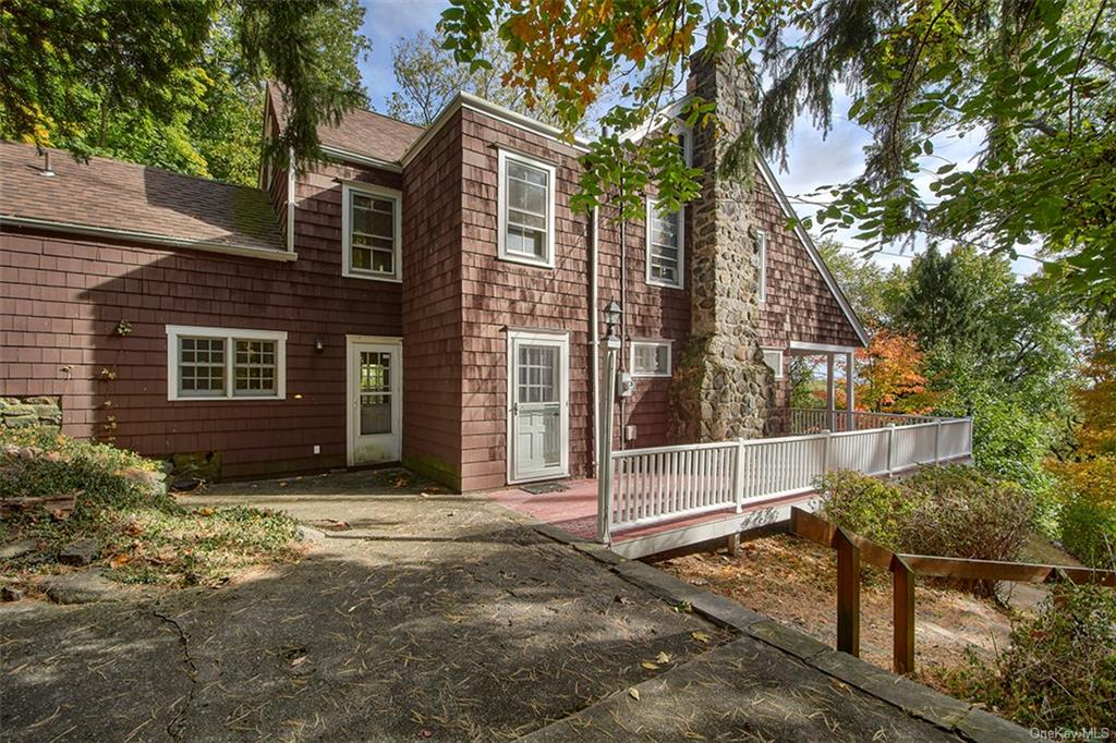 a view of a house with a tree and wooden fence